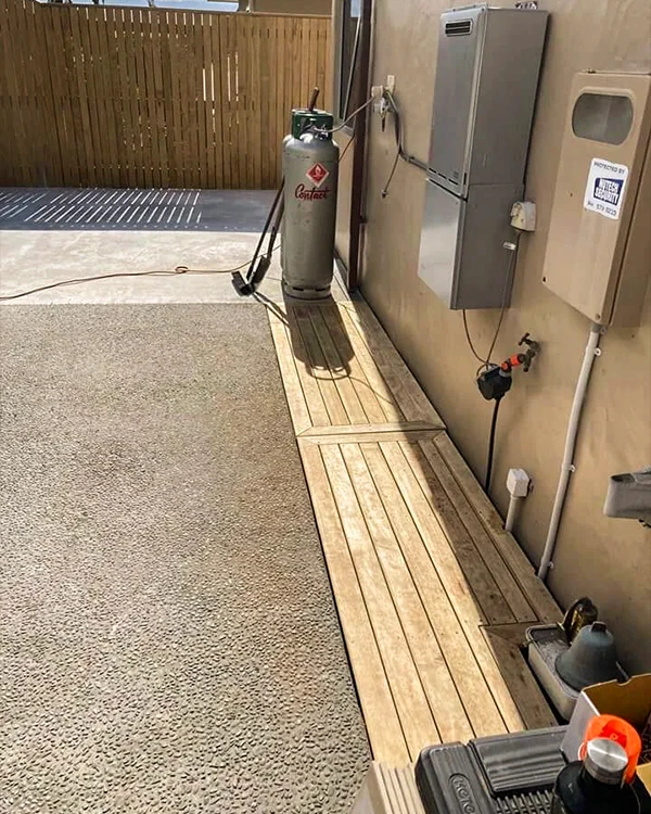 Timber decking covering unsightly drainage and wires at Tauranga residential home